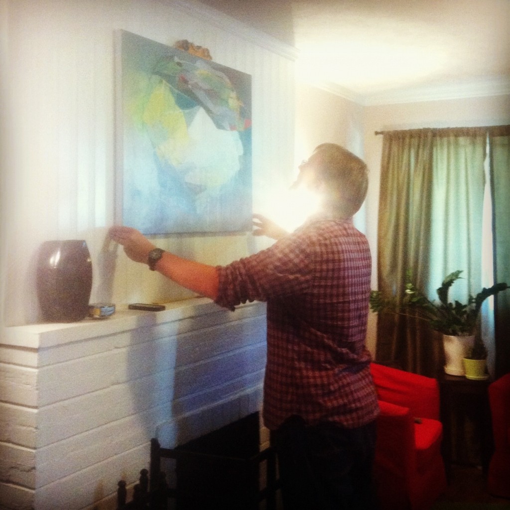 Louie hanging our new painting